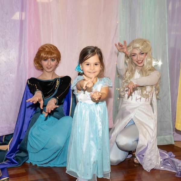 A princess party performer with children at a birthday party
