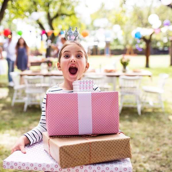 An outdoor garden birthday party with balloons and presents