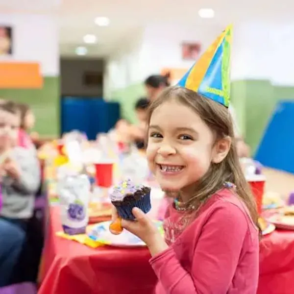 A bright indoor kids party space set up for a celebration