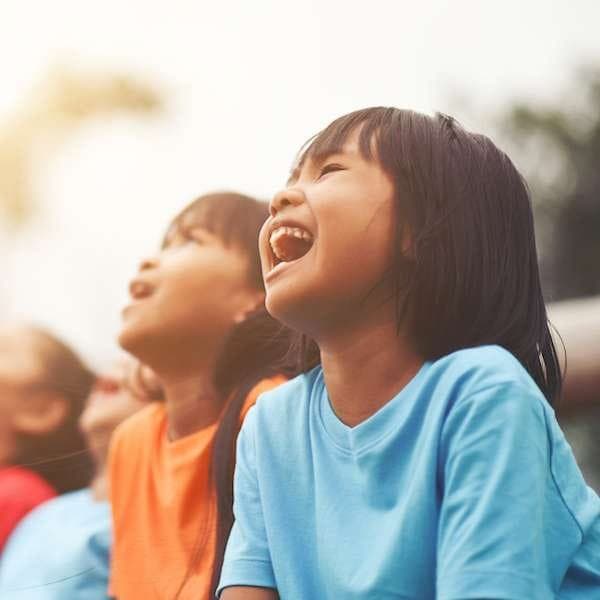 Children laughing in delight at a kids magic show
