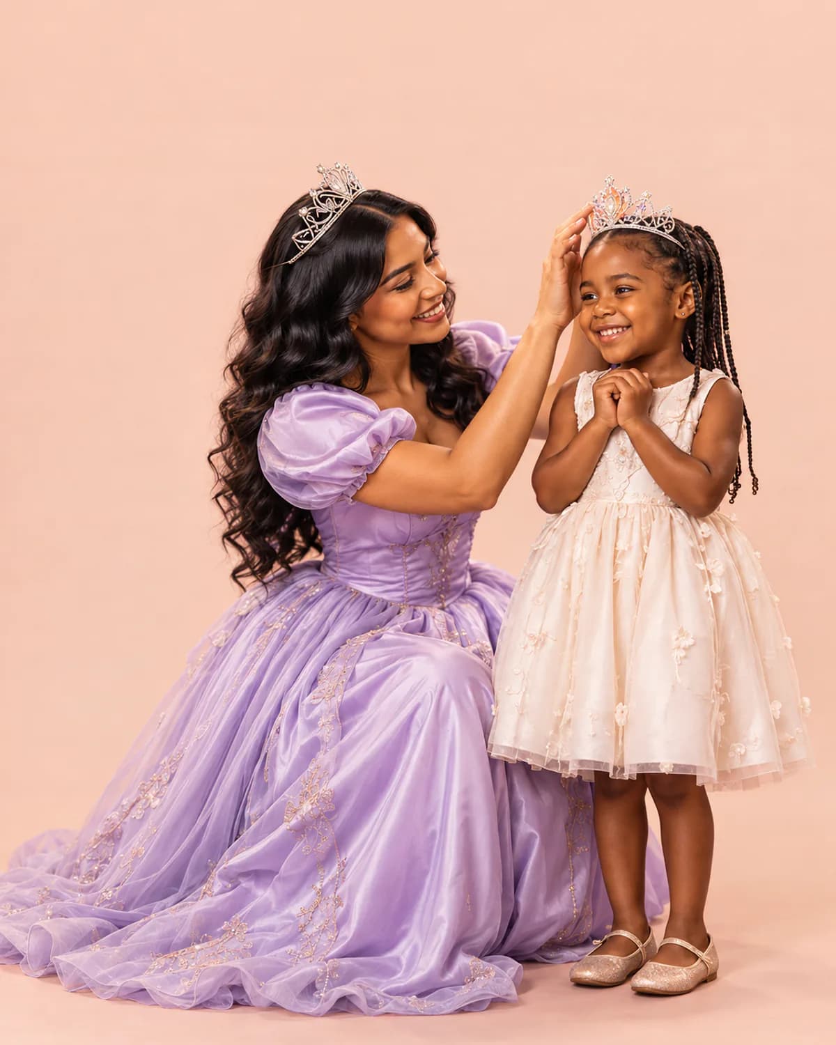 A princess character placing a tiara on a smiling birthday girl